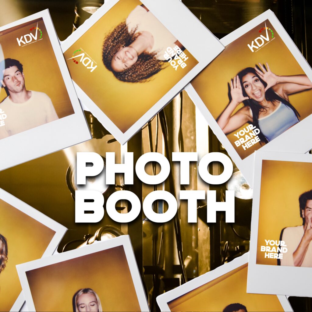 Sponsor-branded photo booth with overlay logo at launch event.