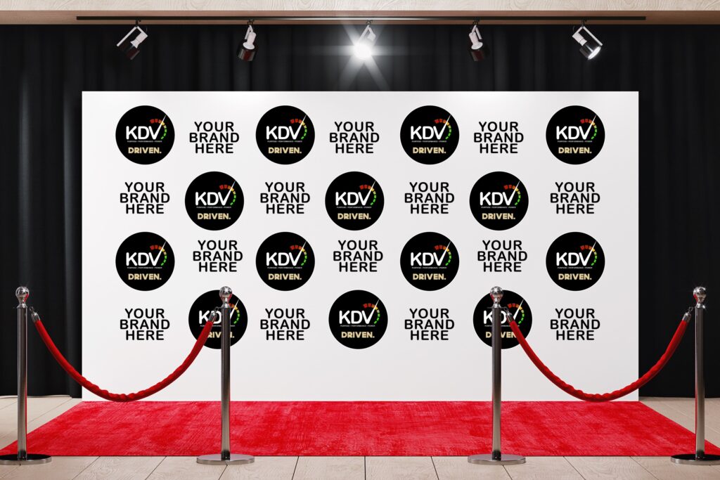 Sponsor-branded step-and-repeat banner displayed at red carpet event featuring K.Le DaVincci logo and media backdrop.